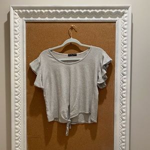 Women’s striped shirt with tie in front.